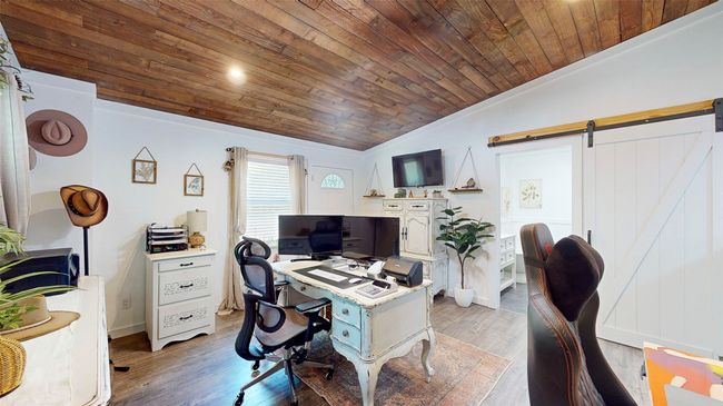 Office space with hardwood / wood-style flooring, ornamental molding, vaulted ceiling, and wooden ceiling | Image 23