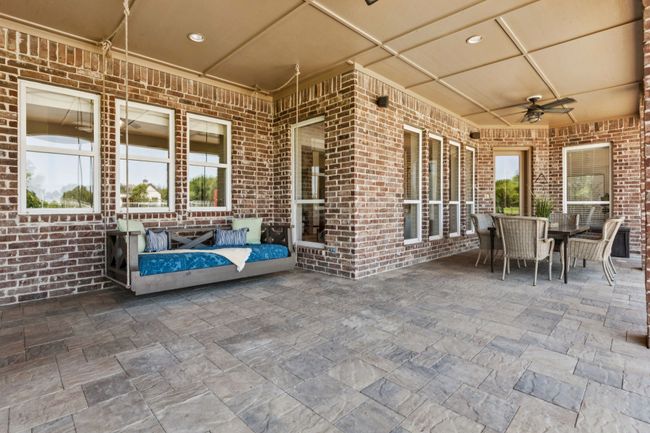 The massive covered patio is just off the main living area and has access to the kitchen. Perfect for outdoor dining or an additional outdoor living area. Not pictured is the outdoor kitchen! | Image 30