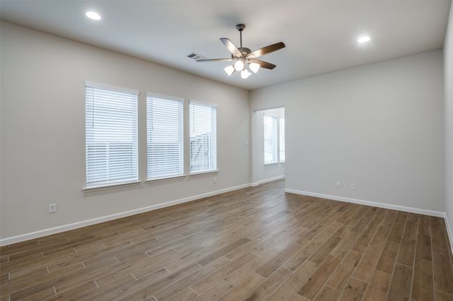 Spare room featuring ceiling fan and hardwood / wood-style floors | Image 8