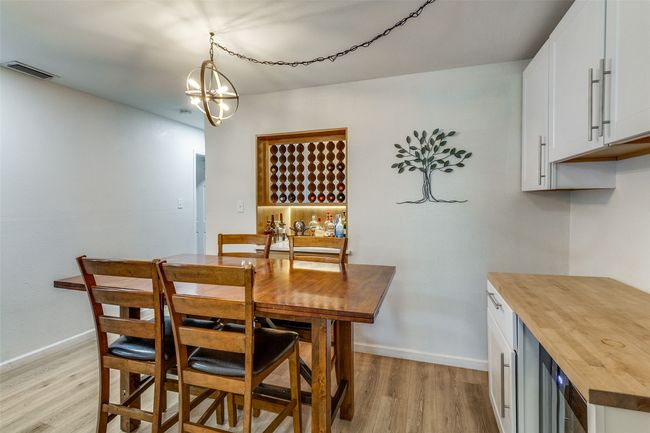 Dining area featuring baseboards, light wood-style floors, visible vents, and an inviting chandelier | Image 10