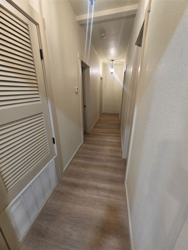 Hall featuring wood finished floors and baseboards | Image 19