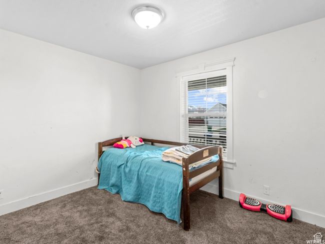 Bedroom with carpet floors and baseboards | Image 7