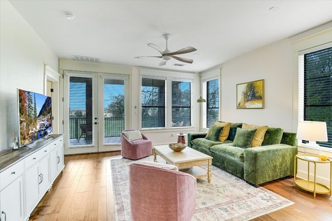 Living area with ceiling fan and light wood-style flooring | Image 5