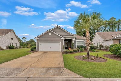 View of front of house featuring a front yard and a garage | Image 1