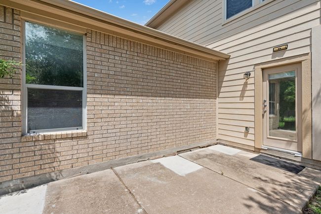 Property entrance featuring a patio area and brick siding | Image 33