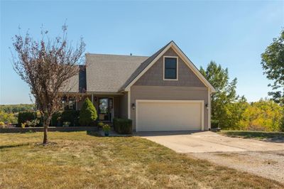 View of front facade with a front yard and a garage | Image 1