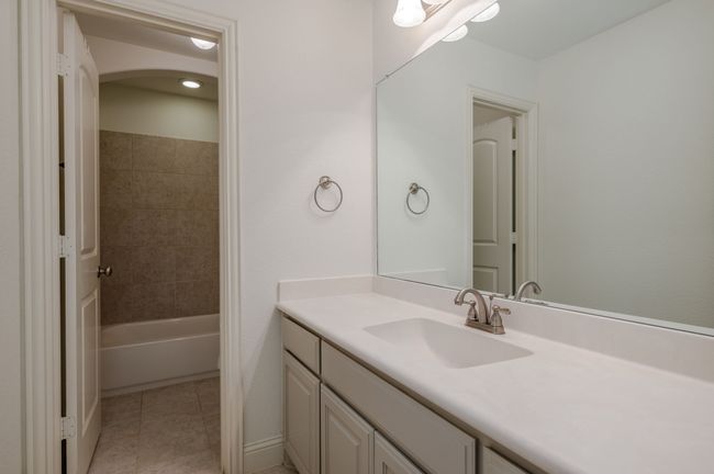 Bathroom featuring vanity, tile patterned flooring, and washtub / shower combination | Image 22