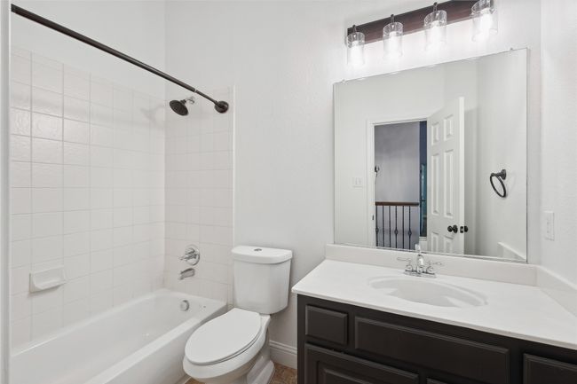 Full bathroom with tiled shower / bath, vanity, and toilet | Image 34