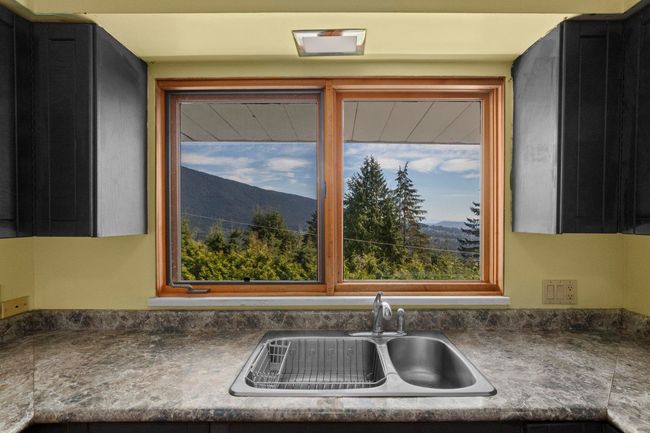 Kitchen with a mountain view and a sink | Image 10