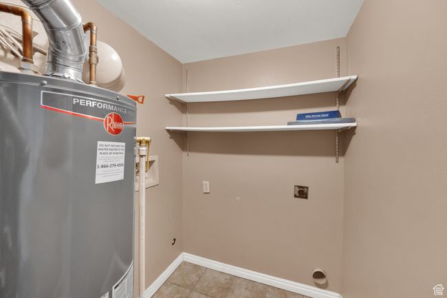 Washroom featuring electric dryer hookup, water heater, washer hookup, and tile patterned flooring | Image 10