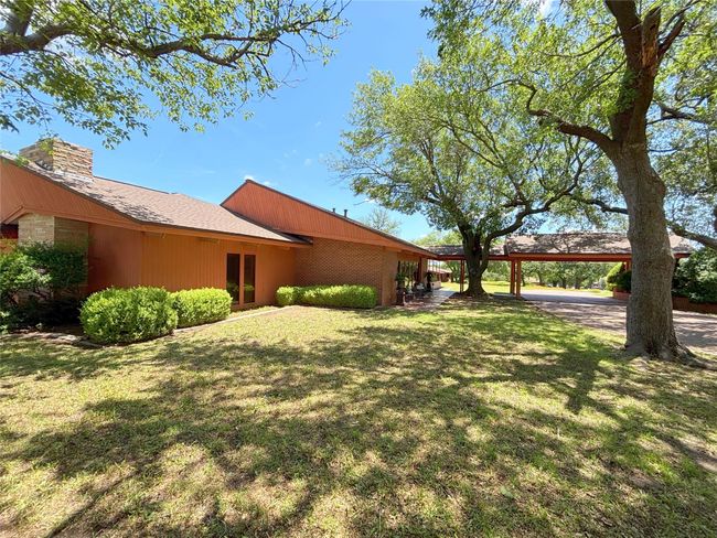 View of green lawn with a carport | Image 5