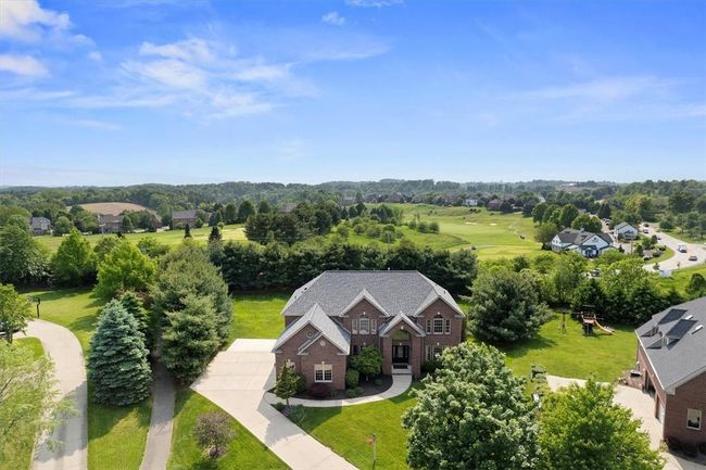 This custom all-brick home is nestled privately on a beautifully landscaped lot. | Image 46