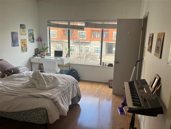 Bedroom featuring multiple windows and wood finished floors | Image 16