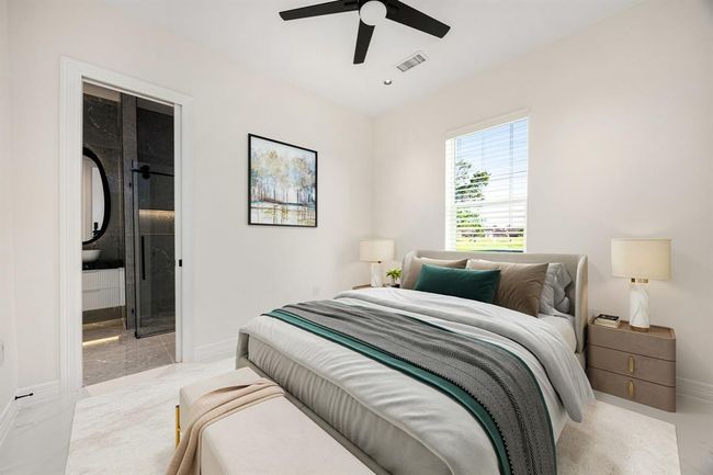 This bright and cozy secondary bedroom features clean modern lines, neutral tones, and a sleek ceiling fan. A large window fills the space with natural light, while plush carpeting and stylish finishes create a comfortable, contemporary retreat ideal for family or guests. | Image 31