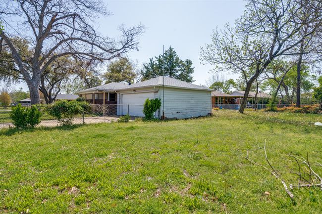 View of yard with fence and a garage | Image 24