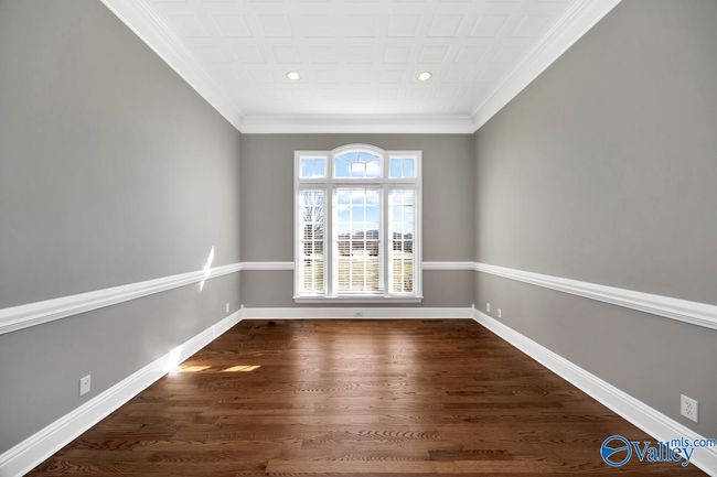 Wood flooring, chair rail, crown molding, recessed lighting | Image 22