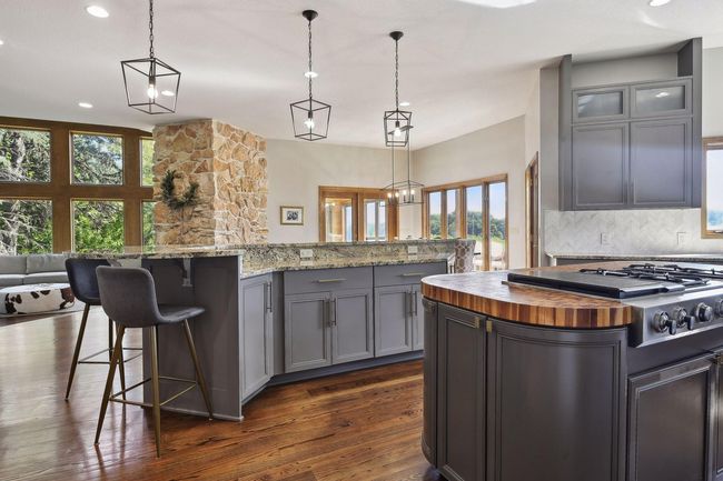 Two islands with built in range, exhaust and beautiful butcher block countertop | Image 5