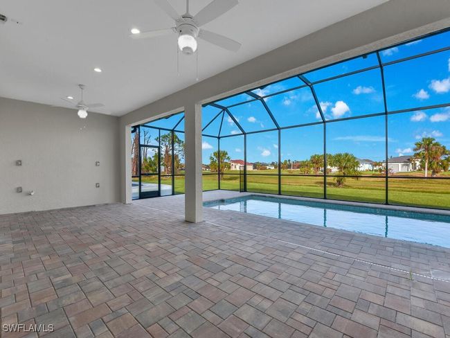 Swimming pool with ceiling fan, a patio area, and a lanai | Image 31