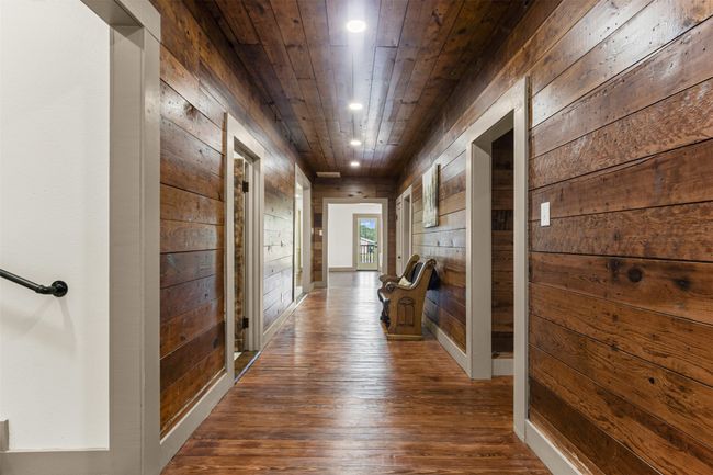 Hallway featuring wood walls, dark wood-style flooring, recessed lighting, and wooden ceiling | Image 31