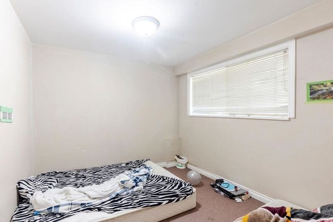 Bedroom with carpet flooring and baseboards | Image 12
