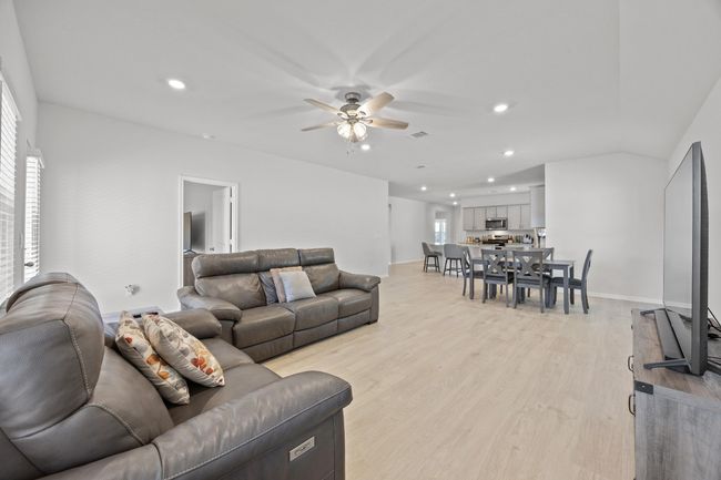 Living area featuring recessed lighting, light wood-look flooring, and a ceiling fan | Image 15