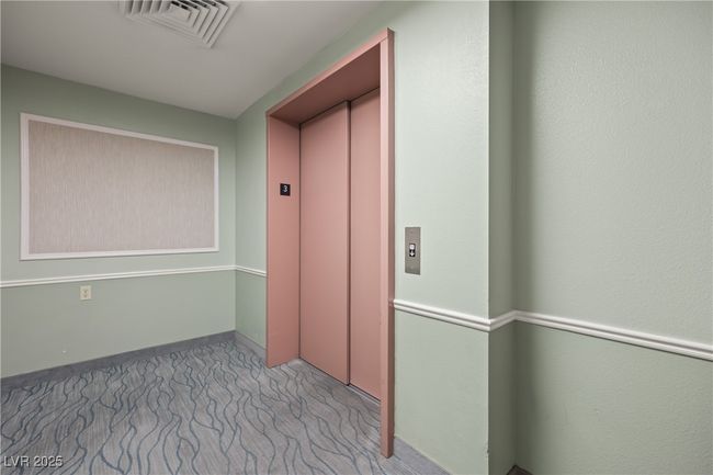Corridor featuring visible vents, elevator, and carpet floors | Image 39