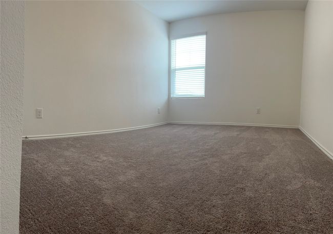 Bedroom with dark colored carpet and baseboards | Image 18