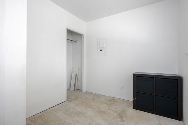 Unfurnished bedroom with carpet floors and electric panel | Image 24