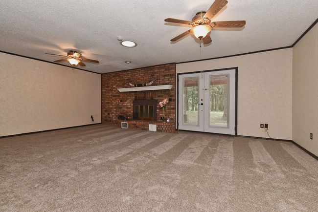 Living room looking out toward back patio and lake | Image 11