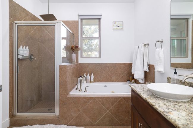 Bathroom featuring a bath, vanity, and a shower stall | Image 19