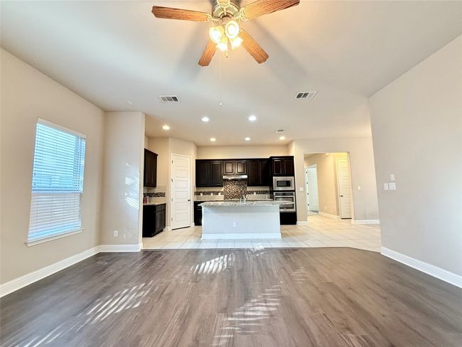 Unfurnished living room featuring light wood-type flooring, recessed lighting, and a ceiling fan | Image 13