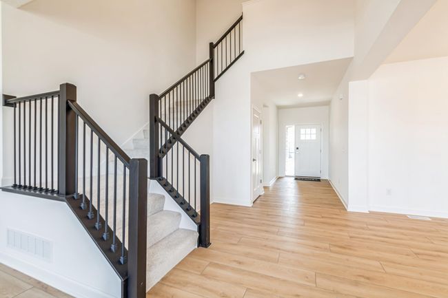 (Photo is of an inventory home, actual homes finishes will vary) Open main entrance/foyer with grand staircase that leads to the upper level four bedrooms, three bathrooms, loft area and a spacious laundry room. | Image 7