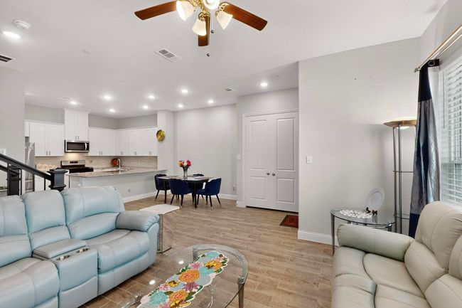 Living area with a ceiling fan, recessed lighting, and light wood finished floors | Image 6