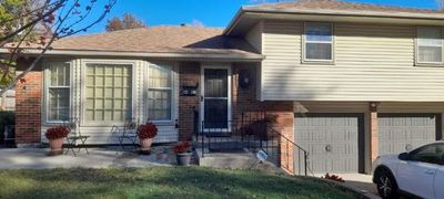 Split level home with a garage and a front yard | Image 3