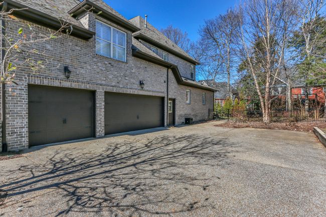 Plenty of parking with a large turnaround and three car garage. | Image 52