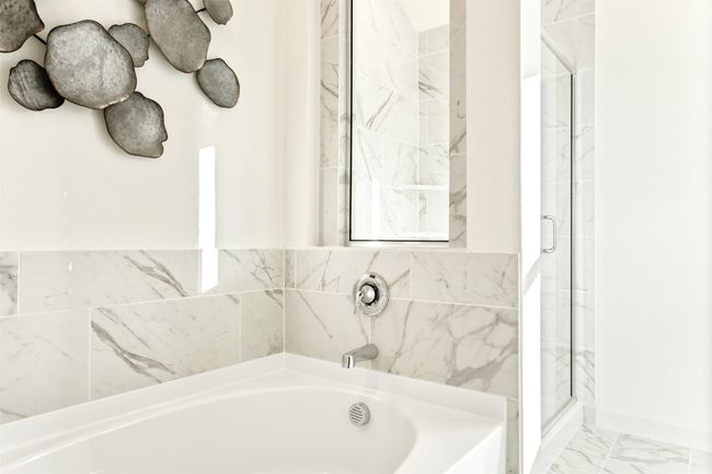 Full bath with a bath, a stall shower, and marble look tiles | Image 31