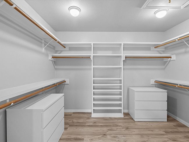Spacious walk-in closet for master bedroom with laminated finished floors | Image 25