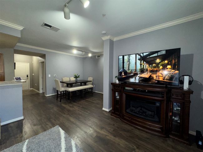 Living room with ornamental molding, track lighting, and dark hardwood / wood-style flooring | Image 8