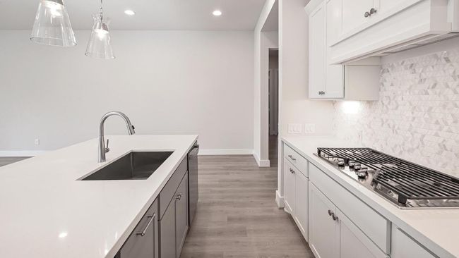 Kitchen featuring white cabinetry, light wood-type flooring, recessed lighting, and backsplash | Image 16