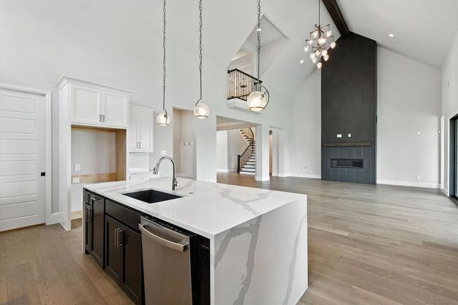 Kitchen with high vaulted ceiling, dishwasher, beam ceiling, light wood-style floors, and open floor plan | Image 15