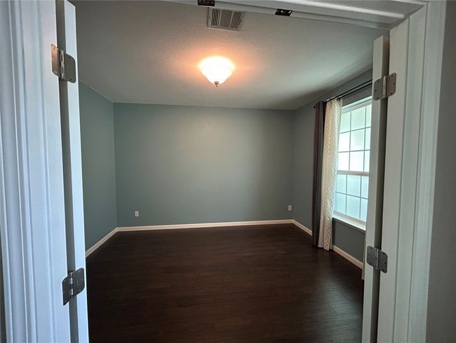 Unfurnished room featuring dark wood finished floors and baseboards | Image 5