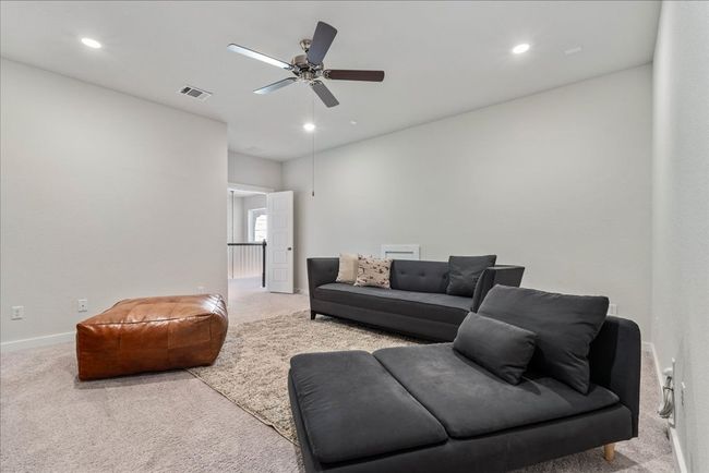 Living area featuring baseboards, recessed lighting, visible vents, ceiling fan, and carpet | Image 30