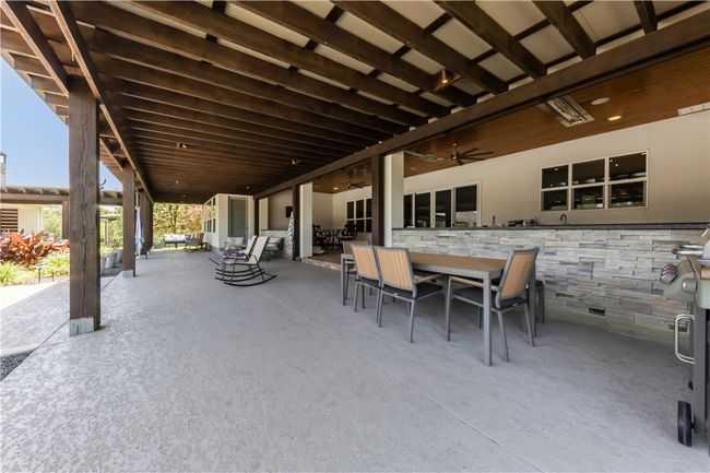 View of patio / terrace featuring outdoor dining area and a ceiling fan | Image 14