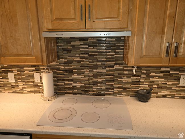 Details featuring light countertops, white electric cooktop, and decorative backsplash | Image 16