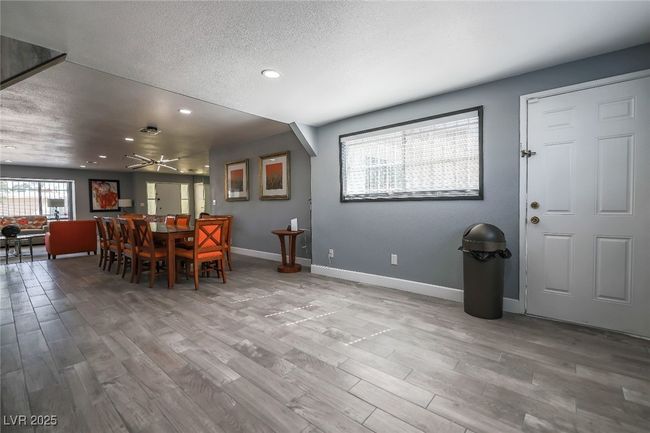 Dining area featuring light wood-style floors, recessed lighting, a textured ceiling, baseboards, and a ceiling fan | Image 24