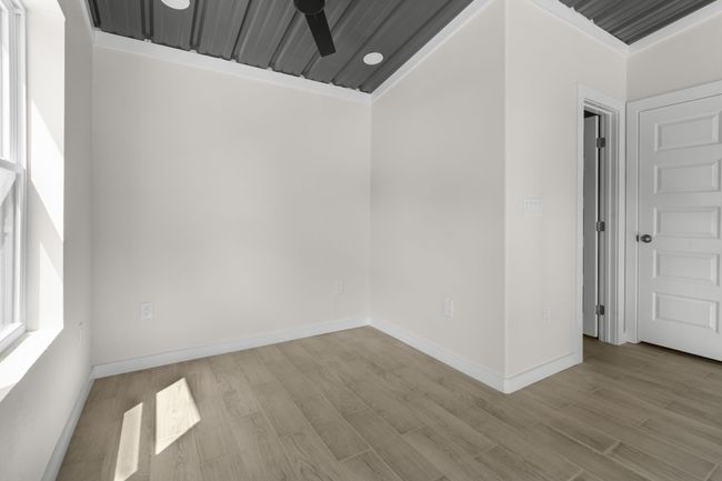 Empty room with a ceiling fan and light wood-type flooring | Image 17