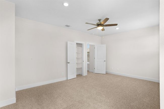 Unfurnished bedroom with light colored carpet, baseboards, recessed lighting, and ceiling fan | Image 18