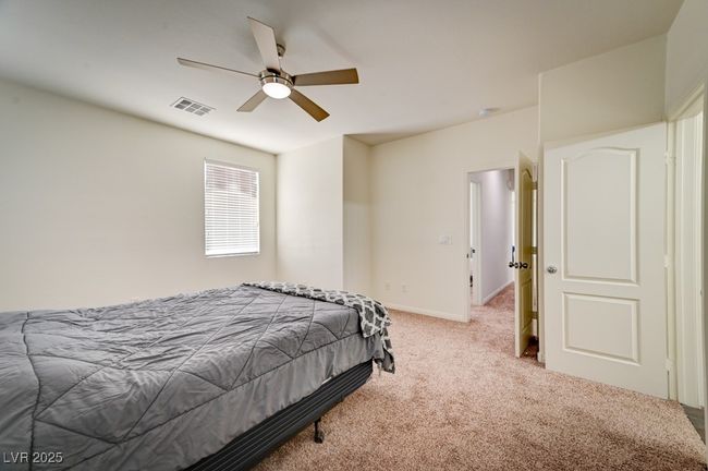 Carpeted bedroom with a ceiling fan and baseboards | Image 21