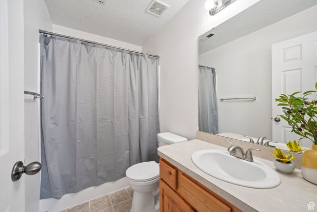 Bathroom with vanity, shower / bath combo, and tile patterned flooring | Image 14