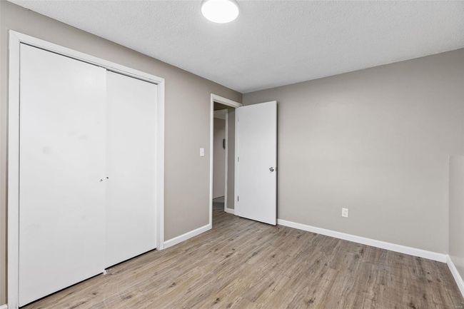 Unfurnished bedroom with baseboards, a closet, light wood finished floors, and a textured ceiling | Image 29
